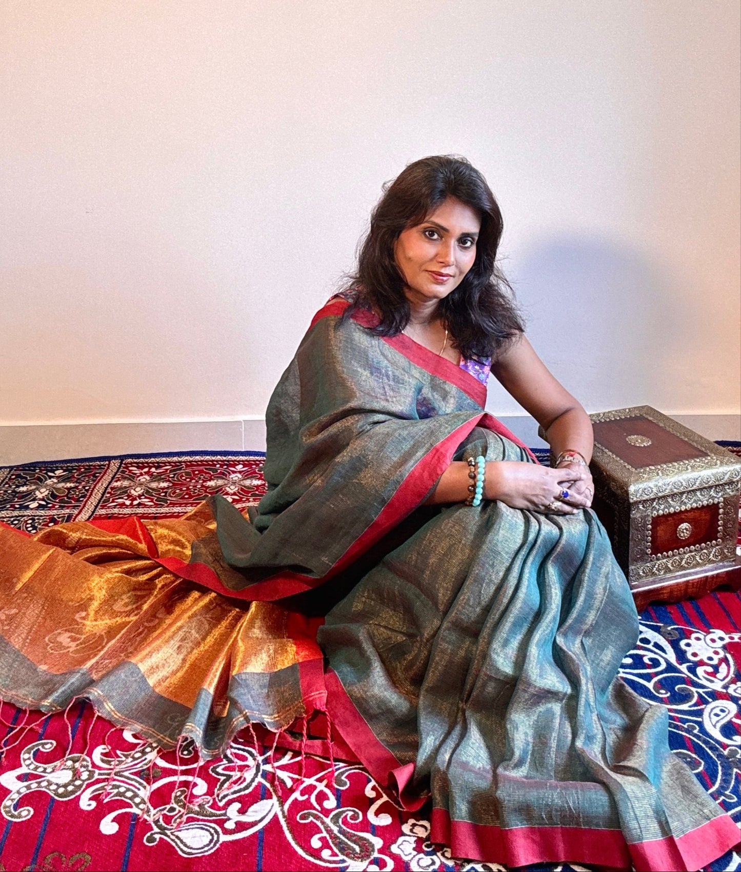Teal Green tissue linen saree with golden zari pallu