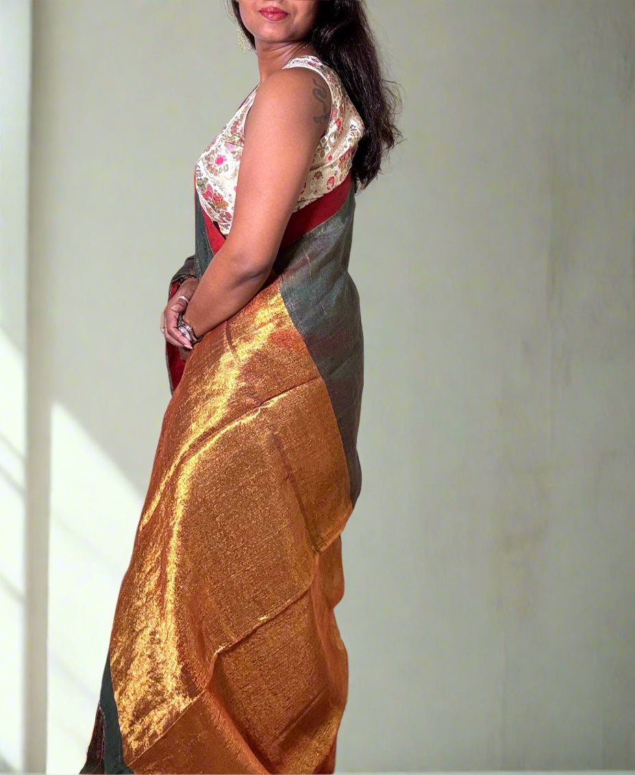 Teal Green tissue linen saree with golden zari pallu